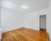 Spare room featuring crown molding and hardwood / wood-style flooring