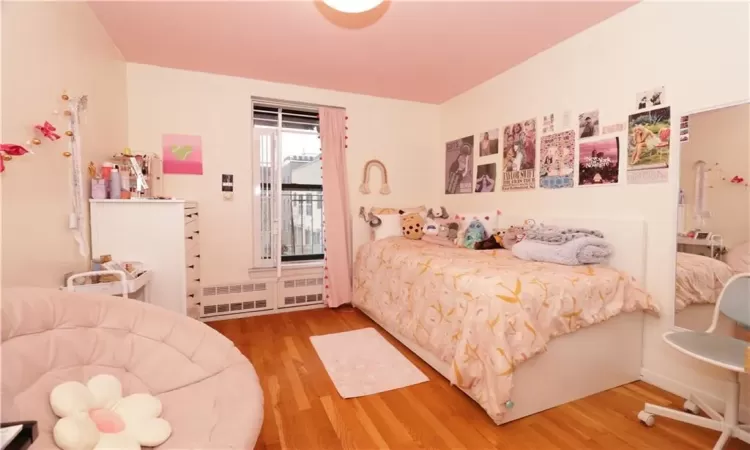 Bedroom with hardwood / wood-style flooring