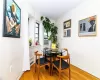 Dining area with cooling unit and light hardwood / wood-style flooring