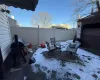 Snow covered patio featuring a grill