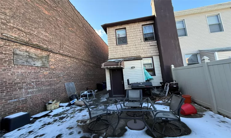 View of snow covered rear of property