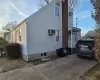 View of property exterior featuring an AC wall unit