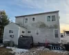 View of snow covered rear of property