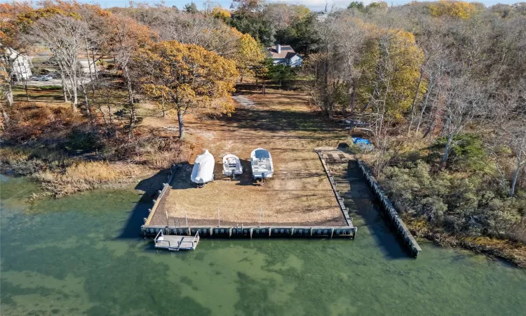 Birds eye view of property with a water view