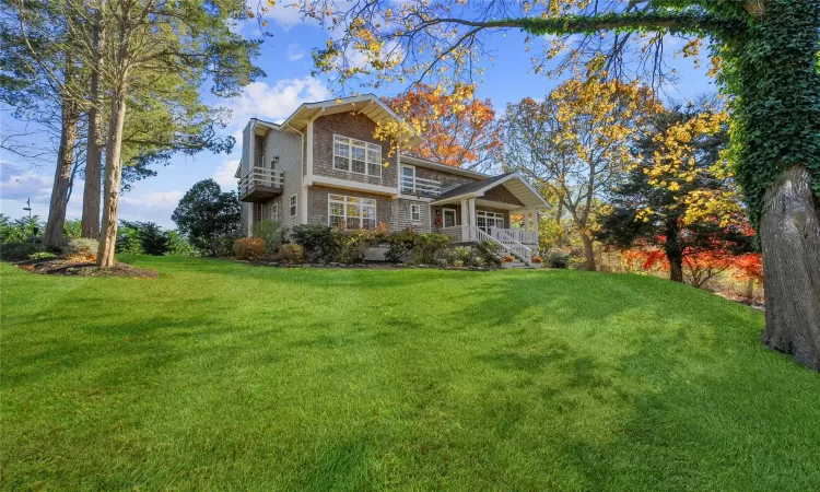 View of front property featuring a porch and a front yard