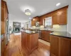 Kitchen featuring a fireplace, sink, stainless steel dishwasher, and plenty of natural light