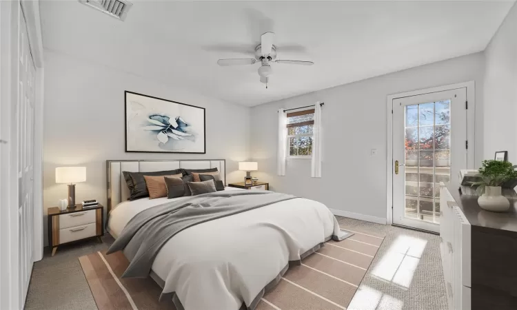 Bedroom featuring carpet, ceiling fan, access to outside, and multiple windows