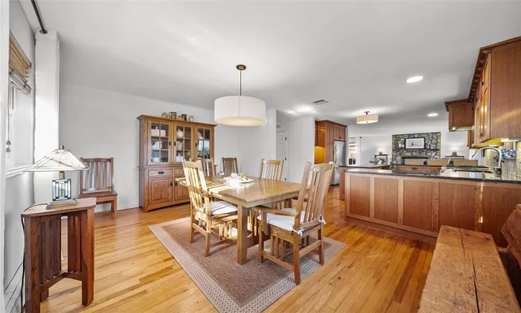 Dining space featuring sink and light wood-type flooring