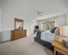 Carpeted bedroom with ceiling fan