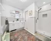 Bathroom featuring vanity and a shower with shower door