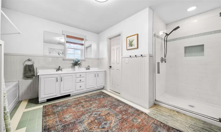 Bathroom featuring vanity and a shower with shower door