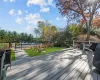 Deck with a swimming pool, an outdoor fire pit, and a lawn