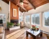 Sunroom / solarium with lofted ceiling with beams, a baseboard heating unit, and wooden ceiling