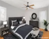 Bedroom with ceiling fan and light wood-type flooring