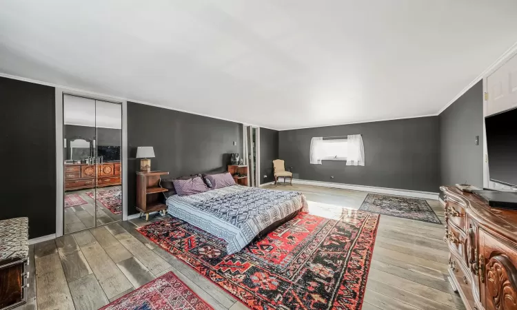 Bedroom with light hardwood / wood-style floors