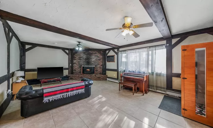 Bedroom featuring light tile patterned flooring, ceiling fan, beam ceiling, and baseboard heating