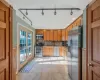 Kitchen with light tile patterned floors, decorative backsplash, sink, and appliances with stainless steel finishes