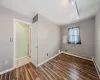 Spare room with track lighting, wood-type flooring, and baseboard heating