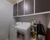 Laundry room featuring washer and clothes dryer and cabinets