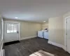 Laundry area featuring baseboard heating, washer and clothes dryer, and dark wood-type flooring