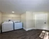 Washroom featuring dark hardwood / wood-style flooring and independent washer and dryer