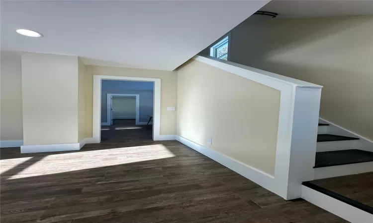 Corridor featuring dark wood-type flooring