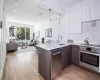 Kitchen featuring sink, white cabinets, dark brown cabinetry, kitchen peninsula, and stainless steel appliances