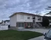 Split foyer home with a garage and a front lawn