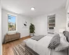 Bedroom with light hardwood / wood-style flooring, cooling unit, and radiator heating unit