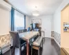 Dining space featuring dark wood-type flooring and a wall unit AC