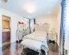 Bedroom with ensuite bath, a wall mounted AC, and sink