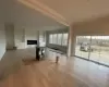 Unfurnished living room featuring ornamental molding, light wood-type flooring, and built in shelves