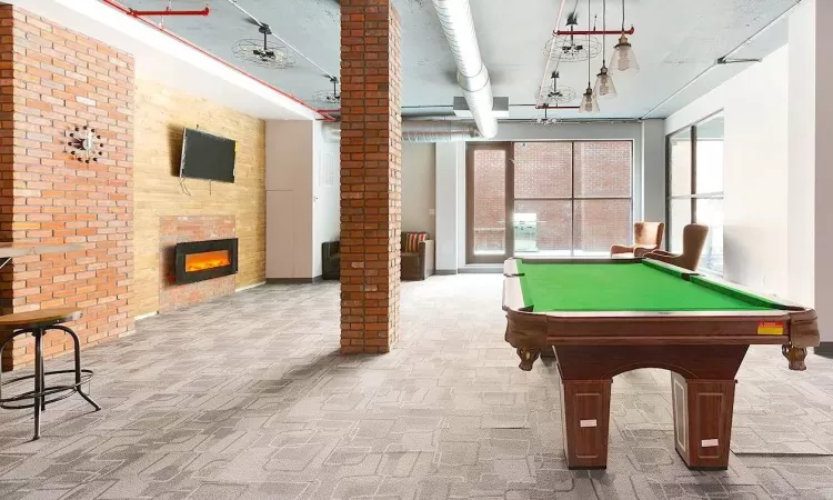 Recreation room featuring pool table, brick wall, and carpet floors