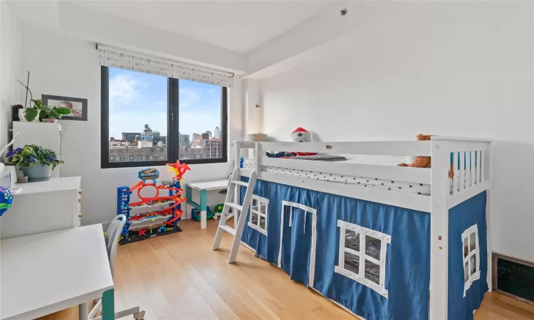 Bedroom with hardwood / wood-style flooring