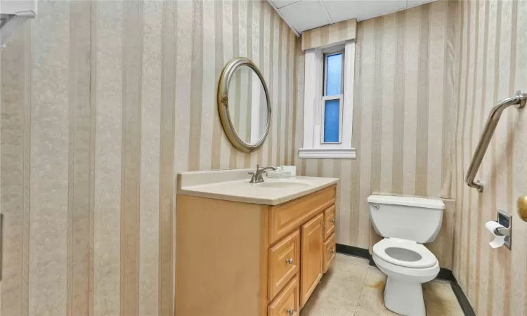 Bathroom with tile patterned floors, vanity, and toilet