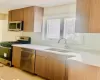 Kitchen with sink, decorative backsplash, and appliances with stainless steel finishes