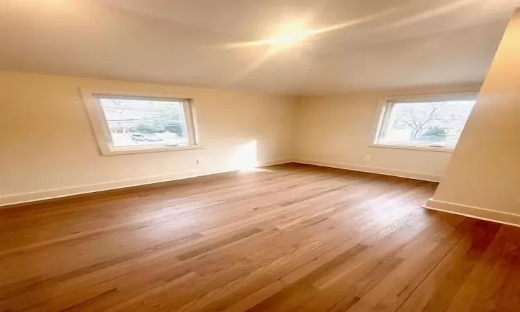 Third Bedroom featuring hardwood / wood-style flooring and lofted ceiling