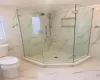 Bathroom featuring an enclosed shower and toilet