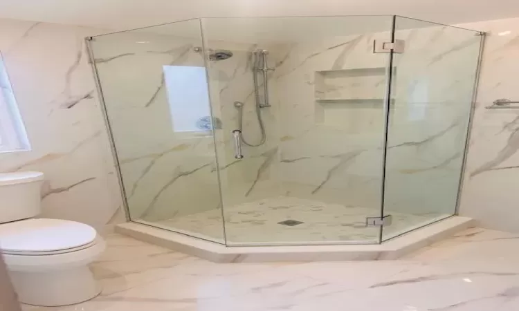 Bathroom featuring an enclosed shower and toilet