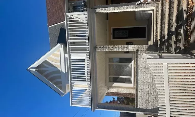 View of front facade with a balcony and covered porch