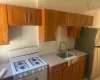 Kitchen with stainless steel fridge, sink, gas range gas stove, and backsplash