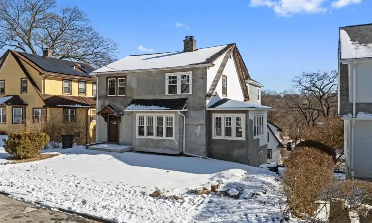 View of snow covered rear of property