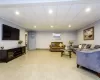 Living room with a paneled ceiling and light hardwood / wood-style floors