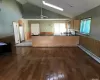 Kitchen featuring baseboard heating, light hardwood / wood-style floors, white appliances, and kitchen peninsula