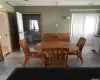 Tiled dining room featuring wooden walls