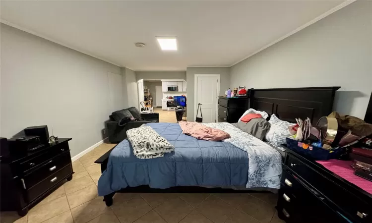 Tiled bedroom featuring ornamental molding