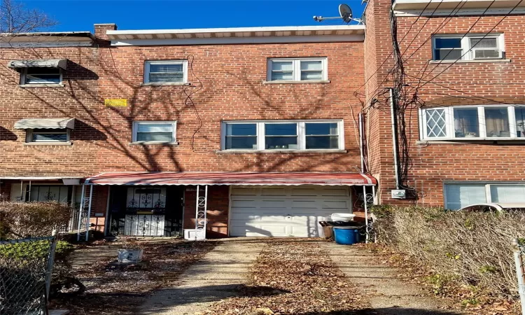 Townhome / multi-family property featuring a garage