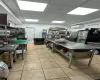 Kitchen with a paneled ceiling, a wall mounted air conditioner, and light tile patterned floors