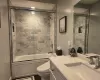 Full bathroom with vanity, shower / bath combination with glass door, and toilet