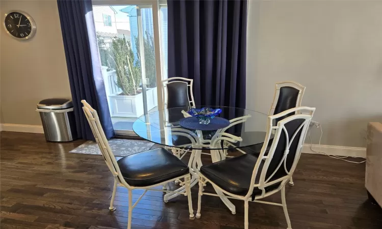 Dining room with dark hardwood / wood-style floors